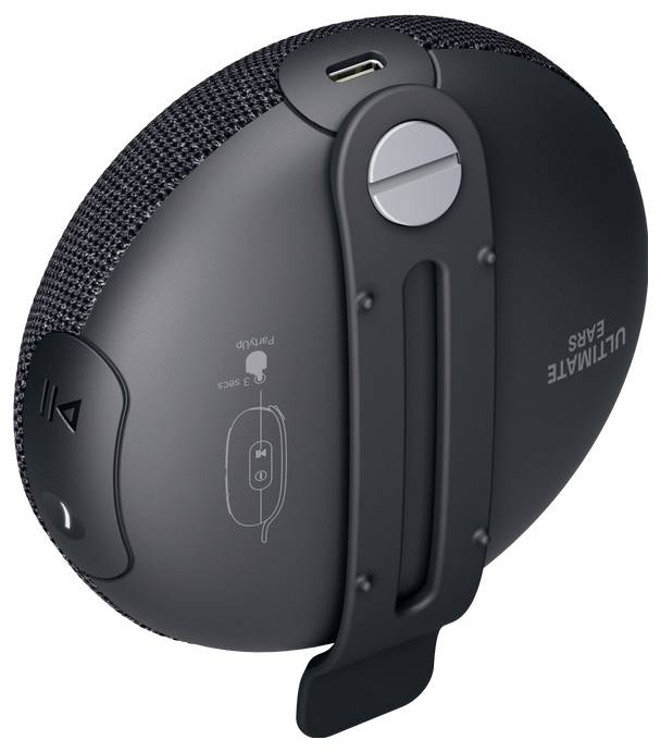 Tragbarer Lautsprecher mit Clip, Mikro-USB-Anschluss und Bedientasten für Wiedergabe und Lautstärke.