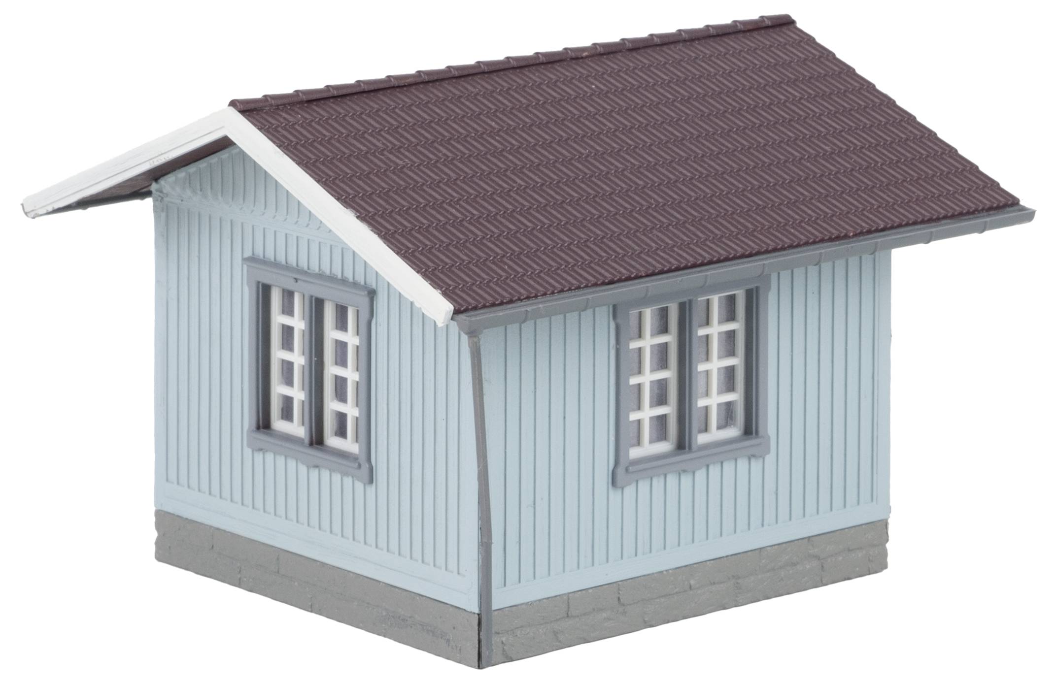 Kleines Modellhaus mit hellblauen Wänden, dunkelrotem Dach und weißen Fensterrahmen, dargestellt aus einer schrägen Perspektive.