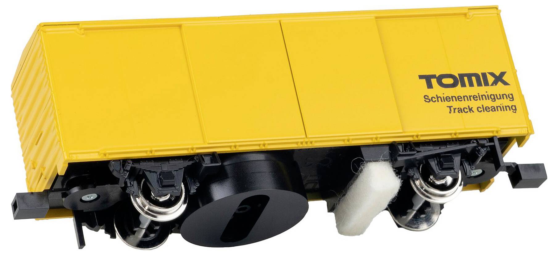 Tomix Gleisreinigungswagen in Gelb für Modelleisenbahnen, mit Reinigungspads im Fahrwerk, gekennzeichnet mit „Schienenreinigung, Track cleaning".