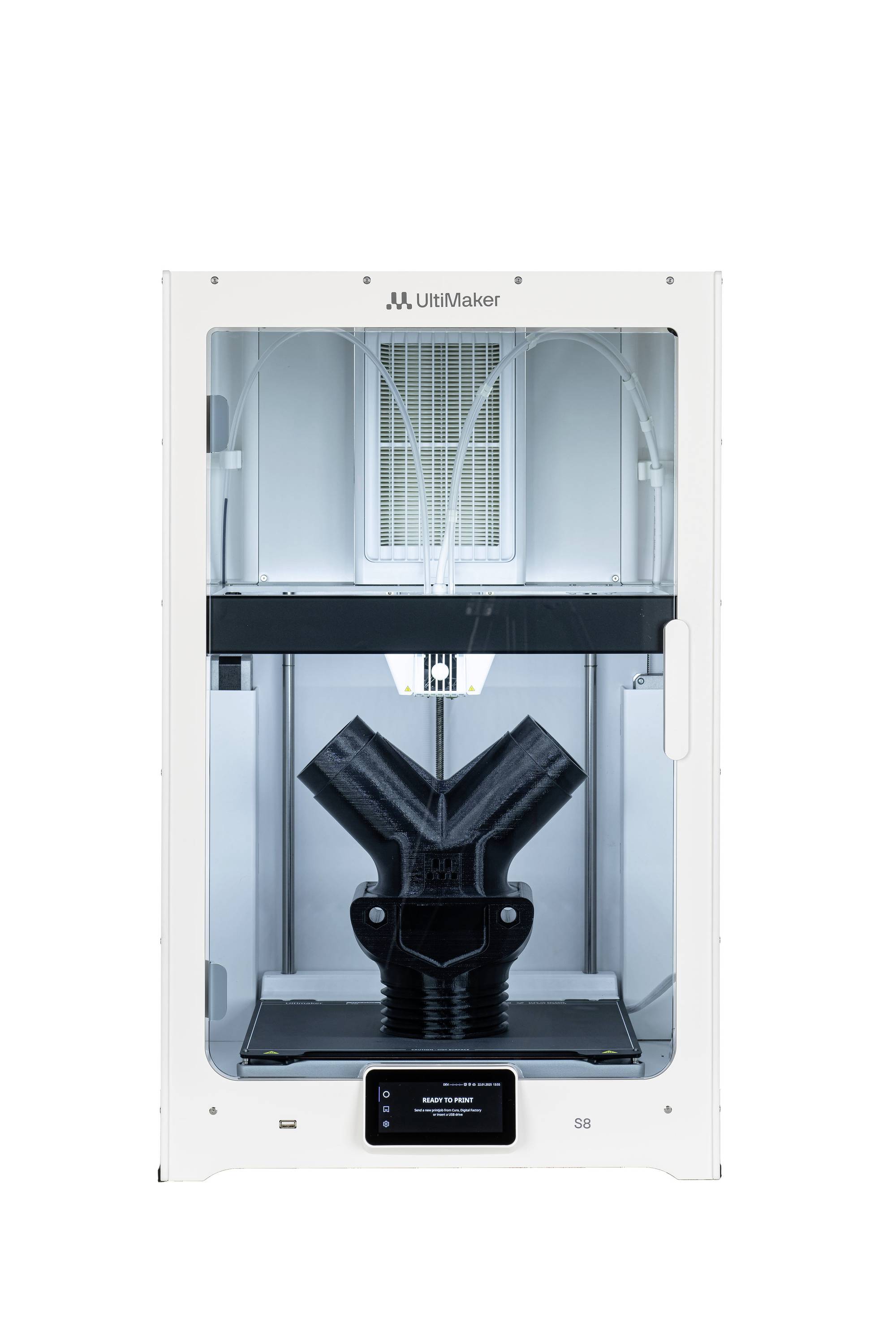 Ein 3D-Drucker druckt ein großes, schwarzes, Y-förmiges Objekt. Der Drucker ist in einem weißen Gehäuse und zeigt fortschrittliche Technik.