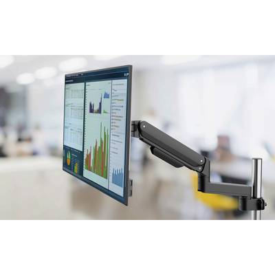 Ein Monitor an einem verstellbaren Arm, der verschiedene Datencharts und Grafiken in einer Büroumgebung zeigt.