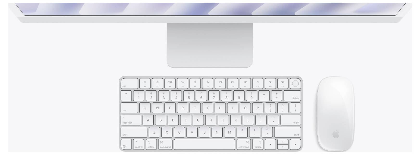 Eine Computereinrichtung mit einem dünnen, schlanken Monitor, der einen unscharfen Bildschirm zeigt, begleitet von einer kompakten Tastatur und einer kabellosen Maus darunter.