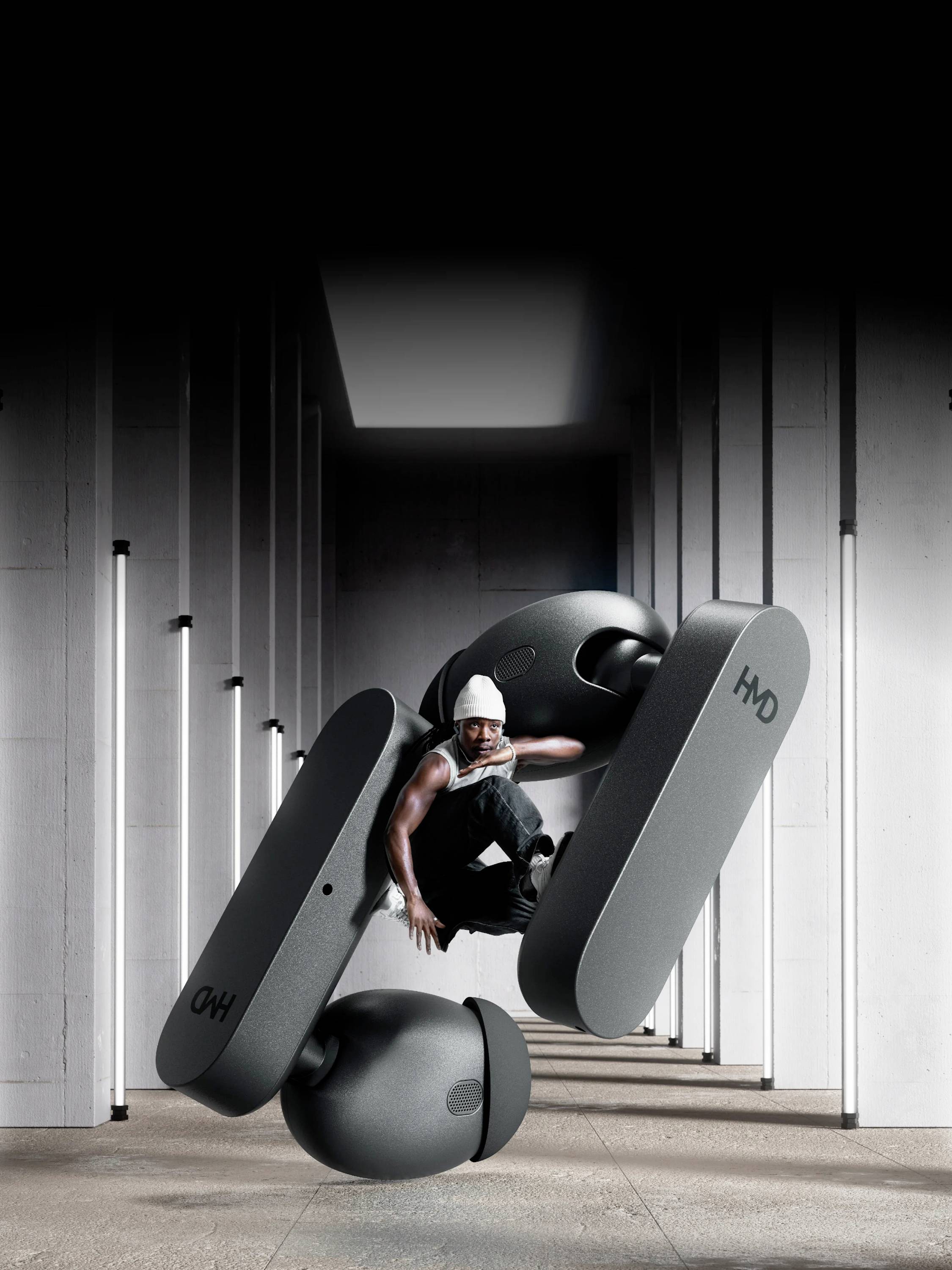 Eine Person in sportlicher Pose zwischen großen, schwebenden Ohrhörern in einem futuristischen, beleuchteten Korridor.