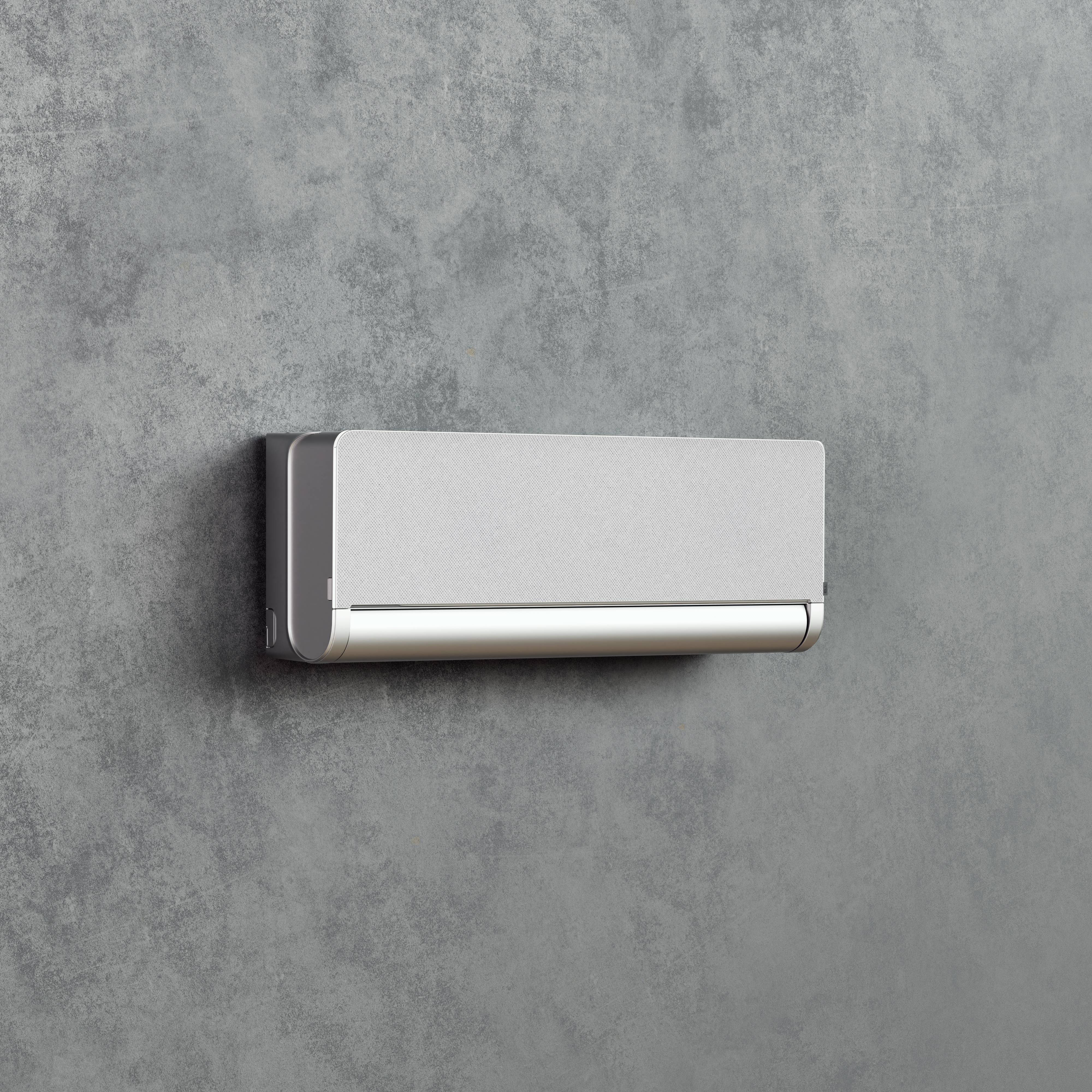 Eine moderne, an der Wand montierte Klimaanlage vor einer grauen Wand. Das Gerät hat ein schlichtes, rechteckiges Design.