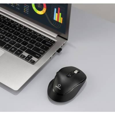 Ein Laptop, der bunte Grafiken zeigt, neben einer drahtlosen Maus auf einer grauen Oberfläche.