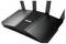 Ein schwarzer ASUS-WLAN-Router mit vier Antennen und blauen Indikatorleuchten, entwickelt für hochgeschwindigkeiten Internetverbindungen.