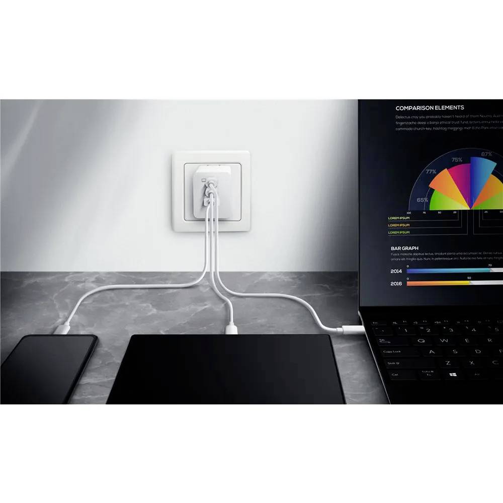 Ein Telefon und ein Laptop laden auf einem Schreibtisch, während in der Nähe ein Diagramm auf einem Bildschirm angezeigt wird.