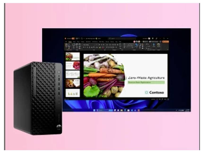 Präsentation "Zero-Waste Landwirtschaft" auf einem Monitor mit verschiedenen Gemüsesorten. Ein schwarzer Computertower steht links daneben.