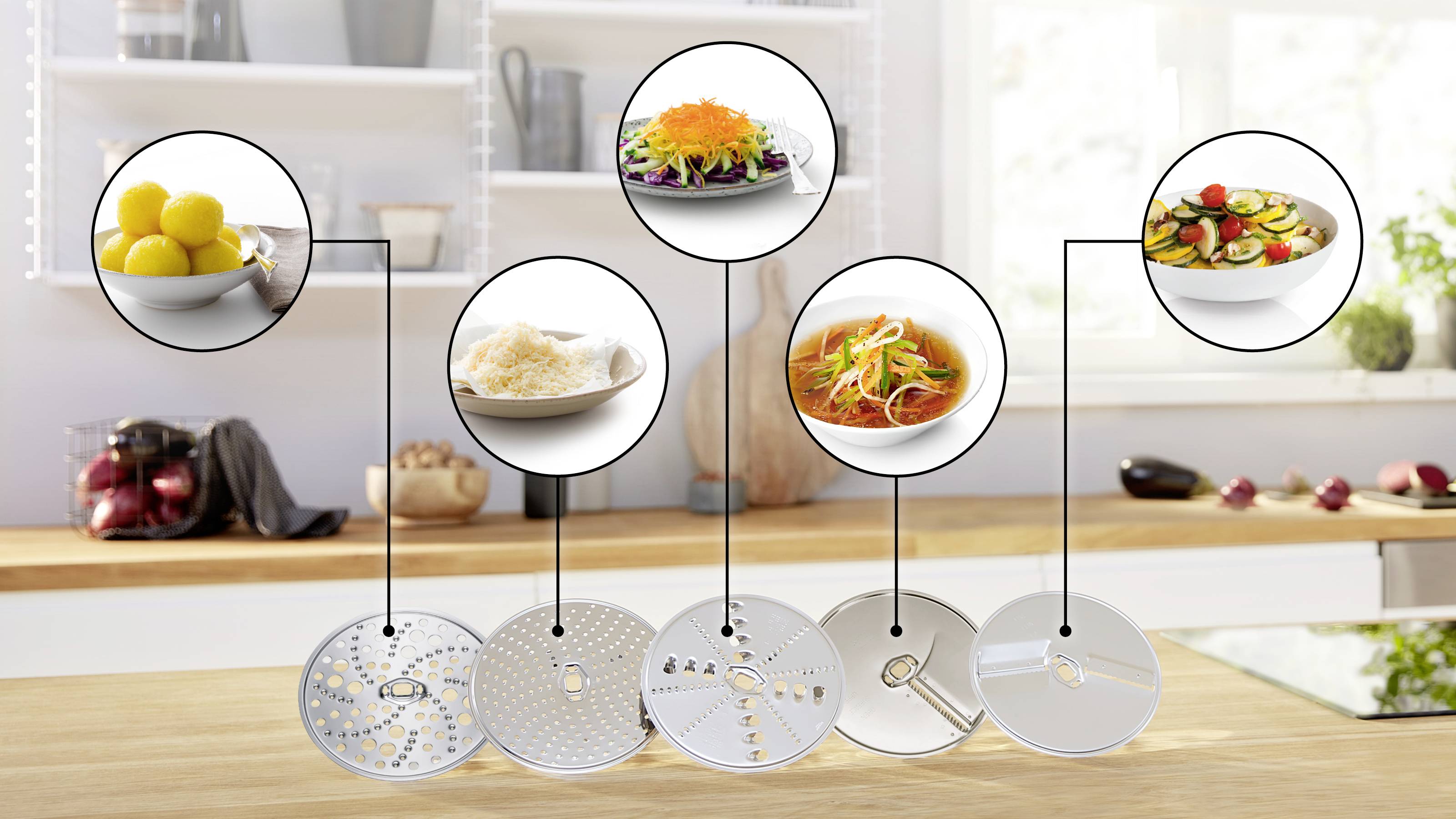 Eine Küchenarbeitsplatte mit verschiedenen Gerichten und Spiralschneider-Klingen. Die Gerichte umfassen Zitronenscheiben, geraspelte Gemüsesorten und eine spiralförmig geschnittene Salat.