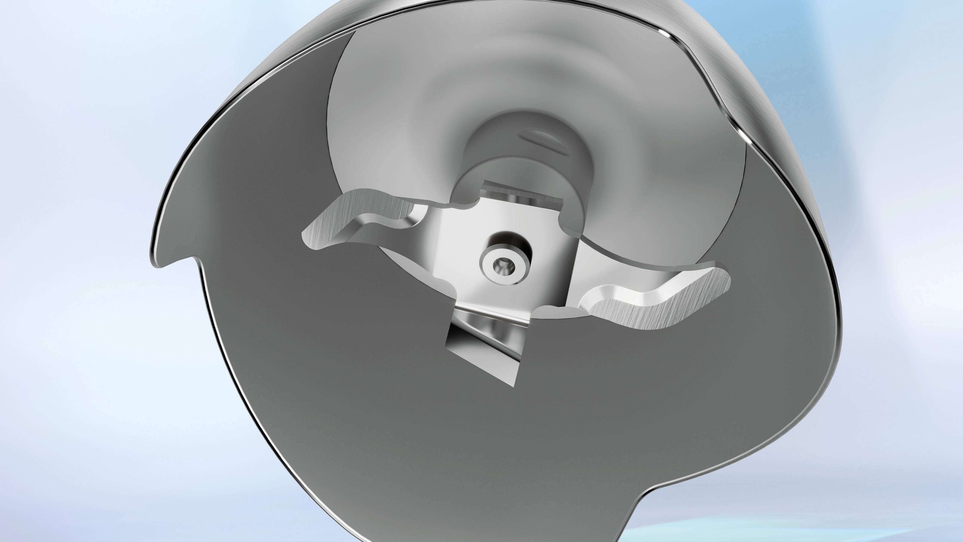 Eine Nahaufnahme einer metallischen Komponente, höchstwahrscheinlich ein technisches Bauteil, mit einer kreisförmigen, hohlen Struktur und einer inneren Befestigung, vor einem blauen Verlaufshintergrund.