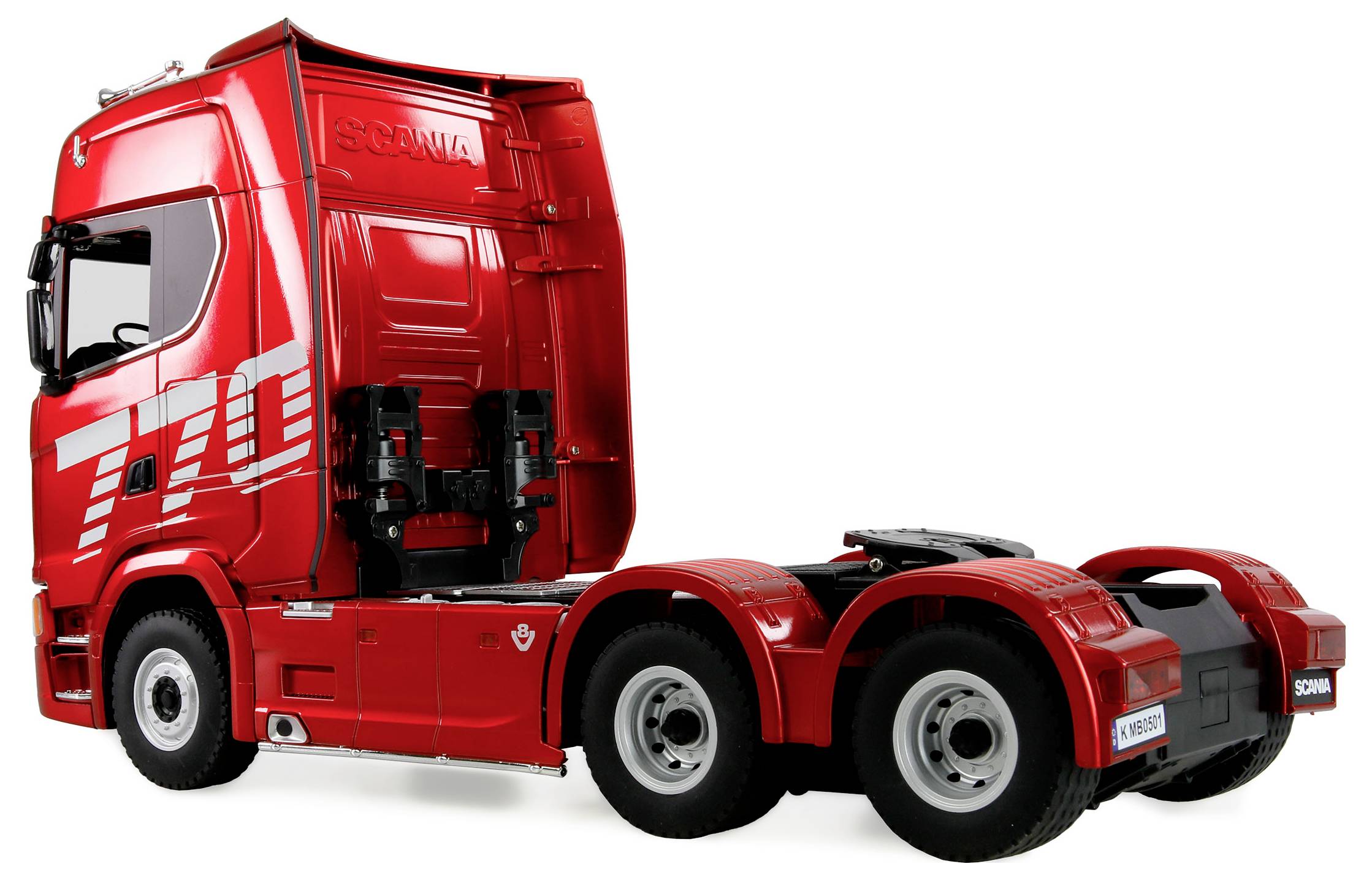 Eine rote Scania-Fahrerkanzel, seitlich betrachtet, mit sichtbarer Fahrerkabine und angeschlossenem Heckfahrgestell. Es ist kein Anhänger angebracht.