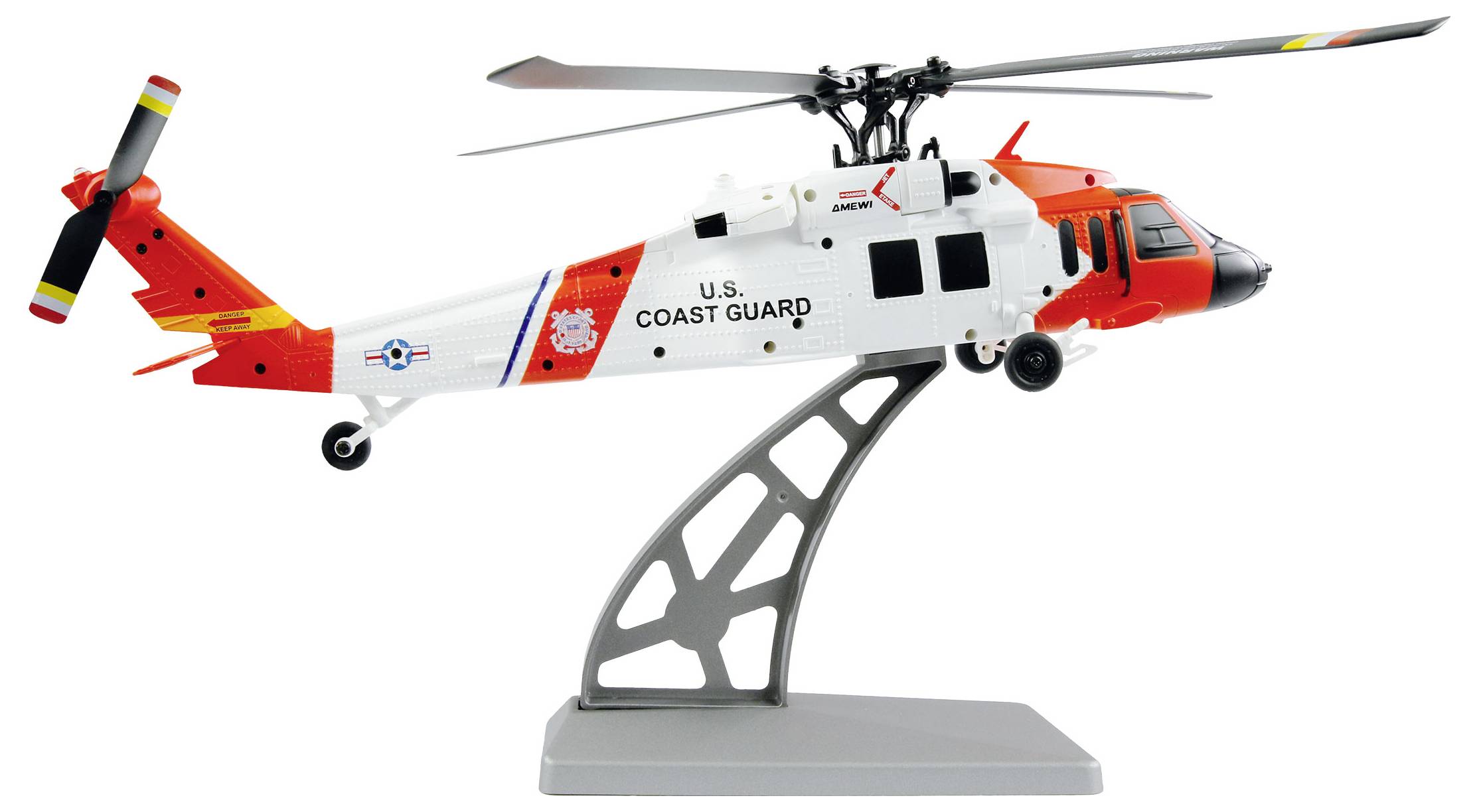 Ein Modell eines Hubschraubers der U.S. Coast Guard auf einem Ständer, mit rot-weißem Design und sichtbaren Details wie Rotorblättern und Dekalen.