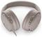 Kabellose Over-Ear-Kopfhörer in einer hellen Tanfarbe, mit einem eleganten Design und Tasten zur Lautstärke- und Wiedergabesteuerung auf der Ohrmuschel.