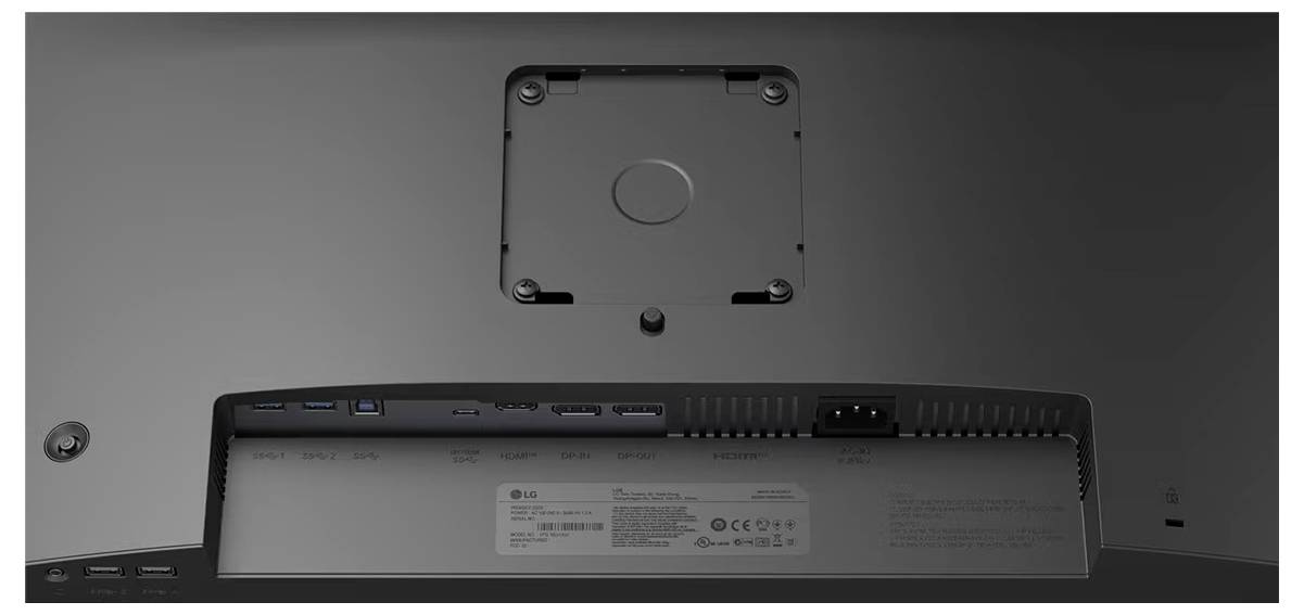 Das Bild zeigt die Rückseite eines LG-Monitors mit verschiedenen Anschlüssen, einem Netzteilanschluss und einem Befestigungshalterungsbereich, der Konnektivitätsoptionen anzeigt.