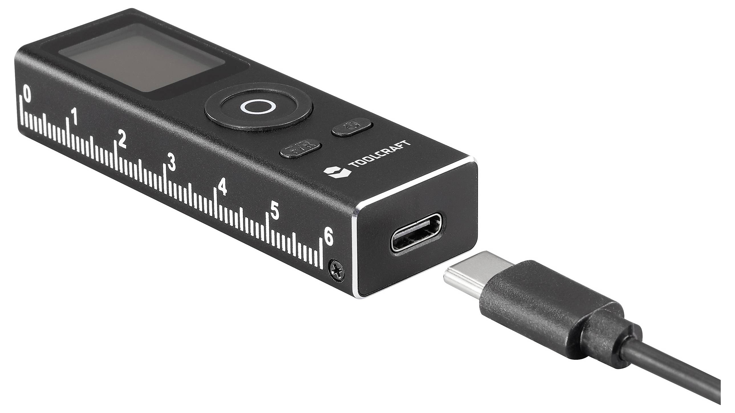 Ein kompaktes schwarzes digitales Gerät mit einem USB-C-Anschluss und einem LCD-Bildschirm, das eine linealähnliche Gestaltung mit Markierungen von 0 bis 6 Zentimetern aufweist.