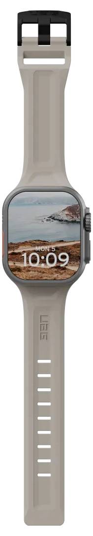 Smartwatch mit einem braunen Band, auf dessen Bildschirm eine digitale Uhrzeit von 10:09 und eine Strand-Hintergrundszene angezeigt wird.