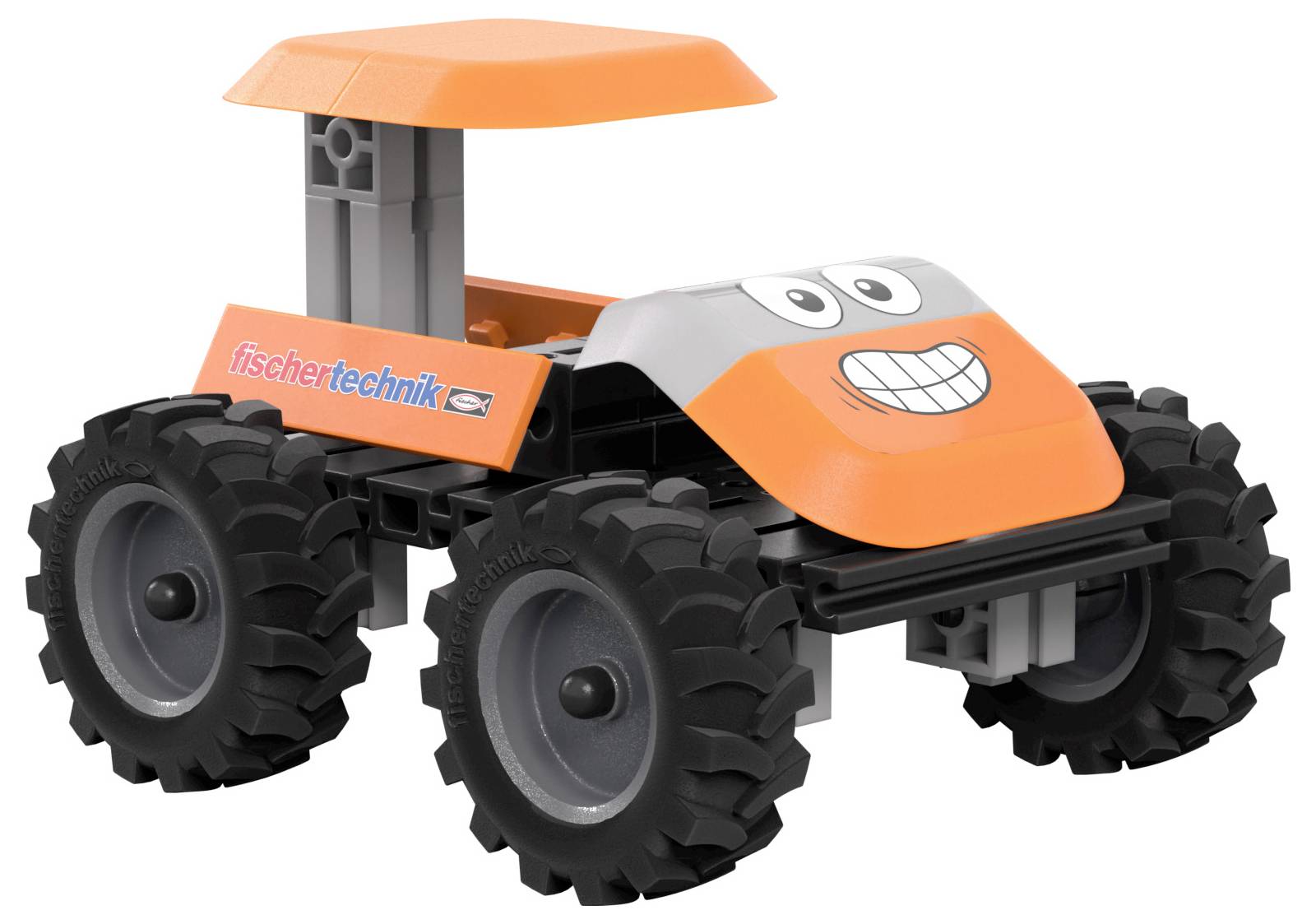 Ein kleines Spielzeugauto mit einem grinsenden Gesicht, breiten Reifen und der Aufschrift 'fischertechnik' an der Seite. Es hat ein flaches orangefarbenes Dach.
