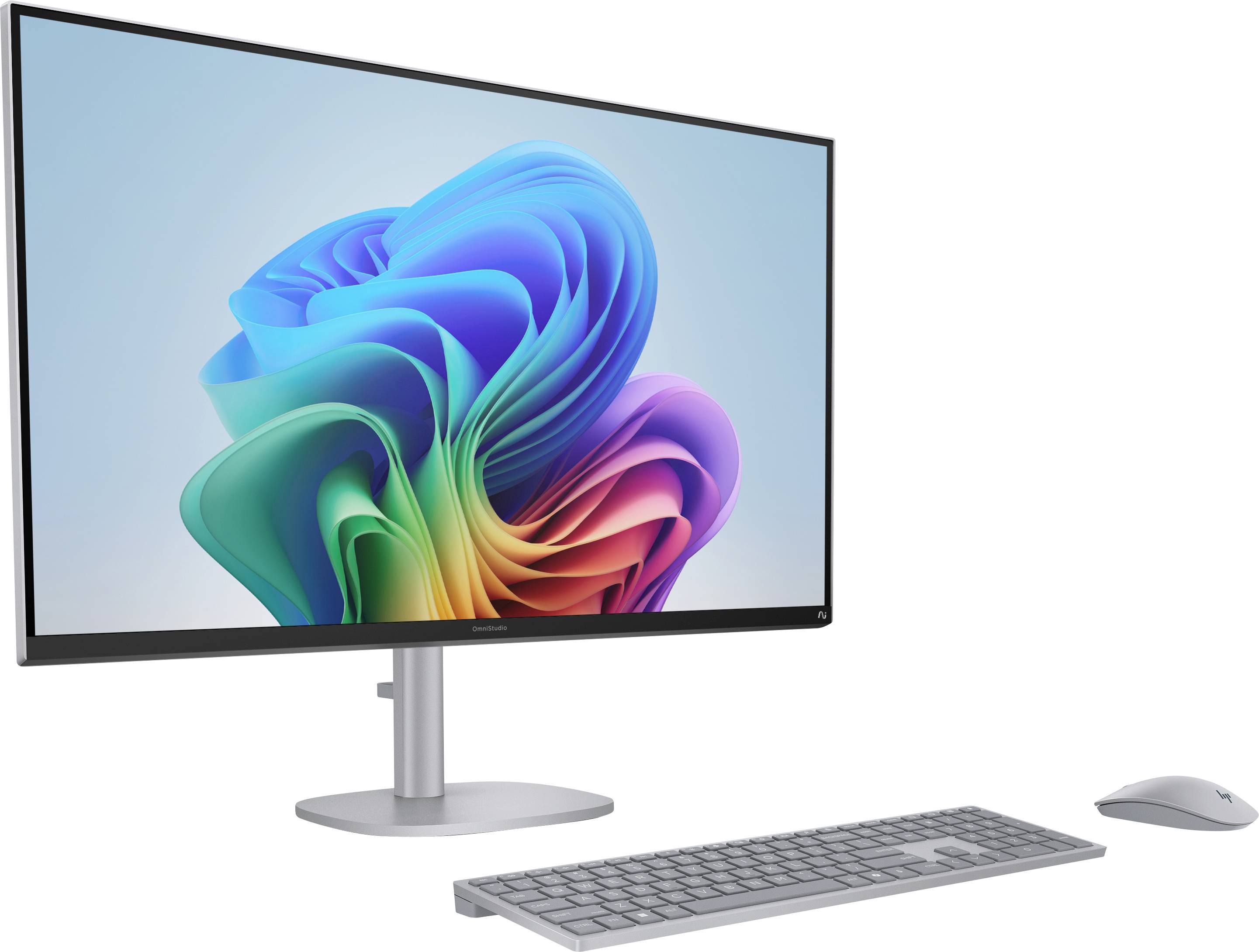 Eine moderne Desktop-Computer-Einrichtung mit einem schlanken Monitor, der ein lebendiges, mehrfarbiges Wirbelmuster zeigt, begleitet von einer Tastatur und einer Maus.