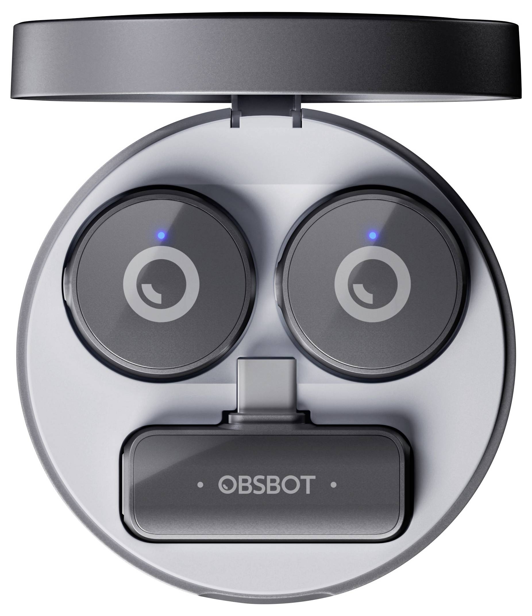 Eine kreisförmige Hülle, die einem Robotergesicht ähnelt, mit zwei Ohrhörer-Fächern als "Augen" und einem als "Mund" gekennzeichneten Ladeanschluss mit der Aufschrift "OBSBOT".