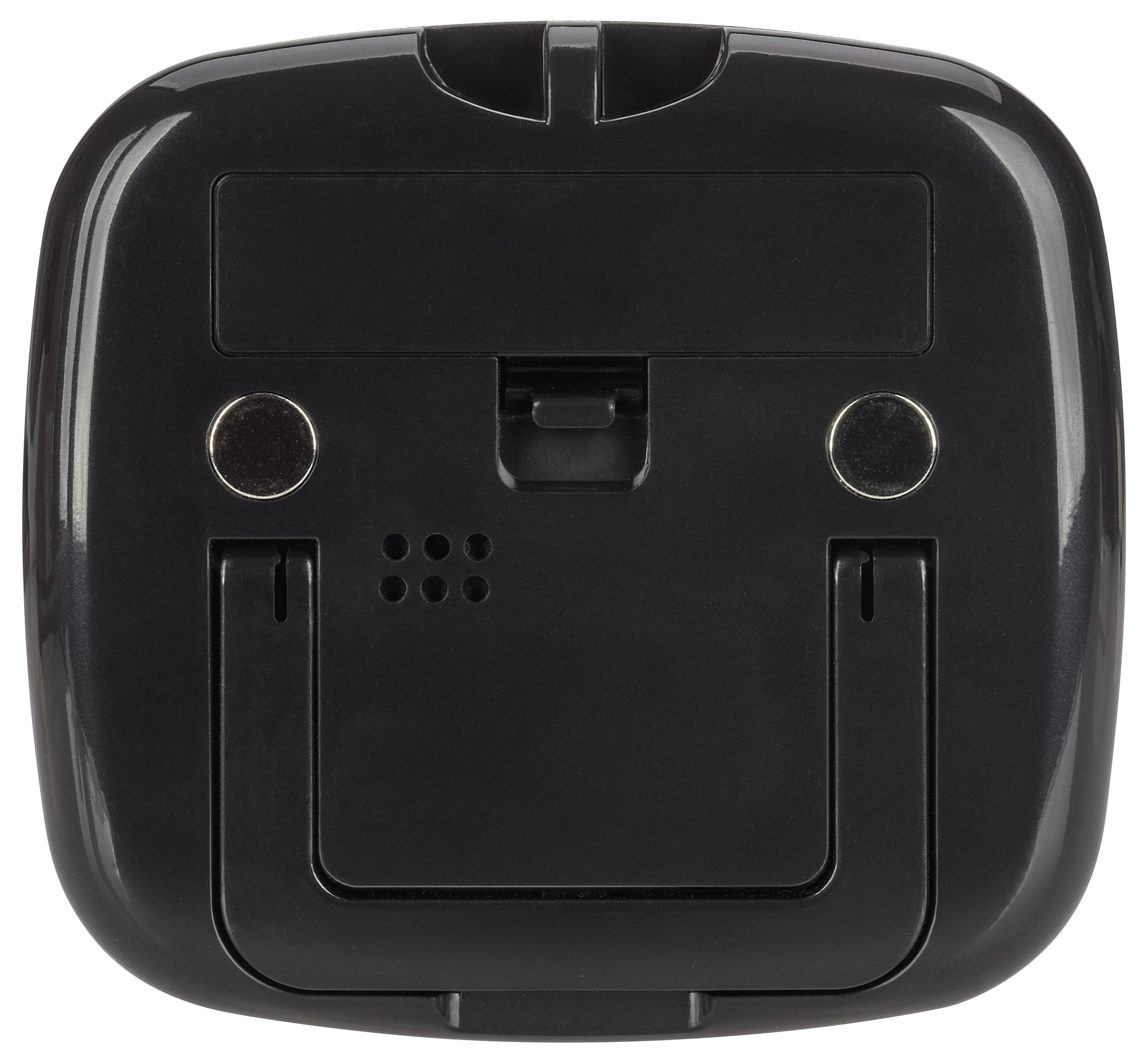 Ein schwarzes Plastik-Elektronikgerät mit zwei runden metallischen Kontakten und einer Vertiefung an der Oberseite, möglicherweise eine Ladestation oder ein Dock.