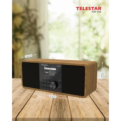 Ein Holzradio mit digitaler Anzeige und Bedienknöpfen auf einem Holztisch. Abmessungen sind beschriftet: 12,5 cm Höhe, 27,9 cm Breite.