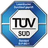 Logo von TÜV SÜD mit Text 'Laserdrucker Durchlauf geprüft. Standard IS-P-002-1' auf einem blau-weißen Oktogon-Emblem.