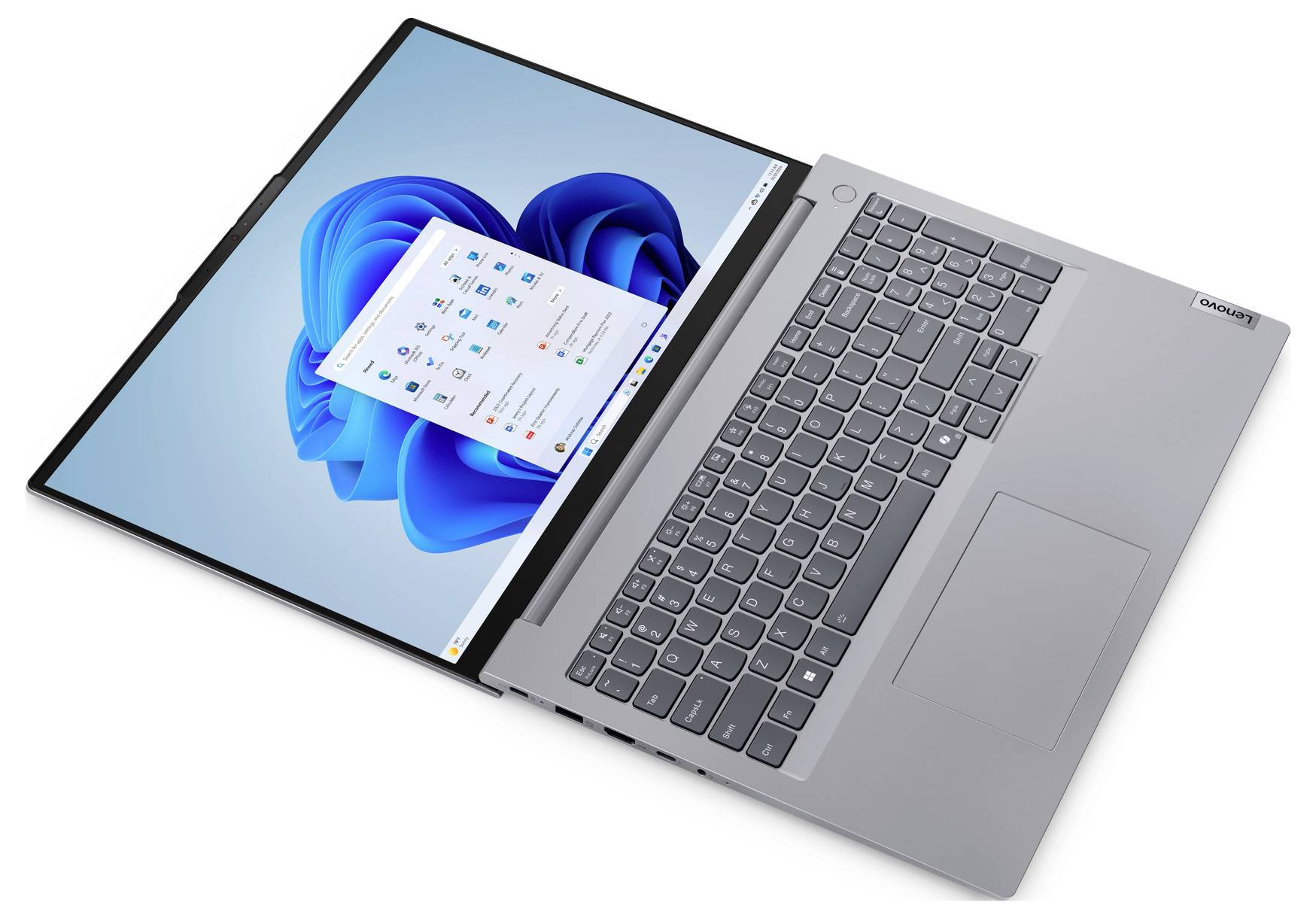 Ein silberner Laptop, der einen Desktopbildschirm mit Windows-Oberfläche zeigt, mit Icons und einem blauen abstrakten Hintergrund, aus einem erhöhten Blickwinkel gesehen.