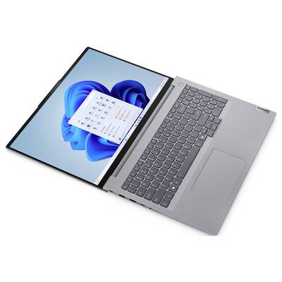 Ein silberner Laptop, flach hingelegt, zeigt einen Bildschirm mit blauem Hintergrund und geöffneten Anwendungsfenstern. Die Tastatur ist sichtbar.