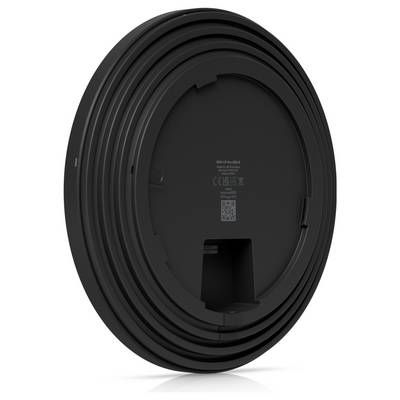 Ein schwarzes rundes Objekt mit konzentrischen Ringen und einer eingesenkten Mitte, das die Rückseite eines elektronischen Geräts oder Gadgets ähnelt.