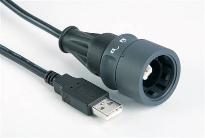 USB-Anschluss neben einem kreisförmigen schwarzen Gerät mit beschrifteten Tasten.