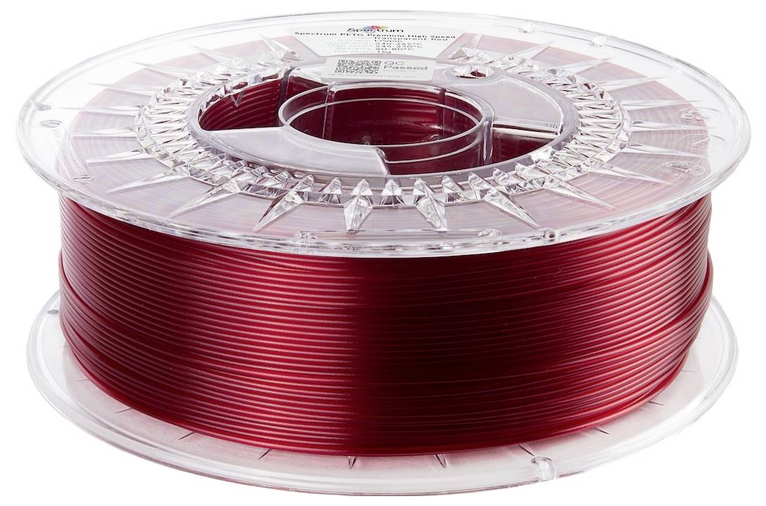 Eine Spule roten 3D-Druckerfilamentes, ordentlich in einem transparenten Plastikbehälter gewickelt, bereit für 3D-Druckprojekte.