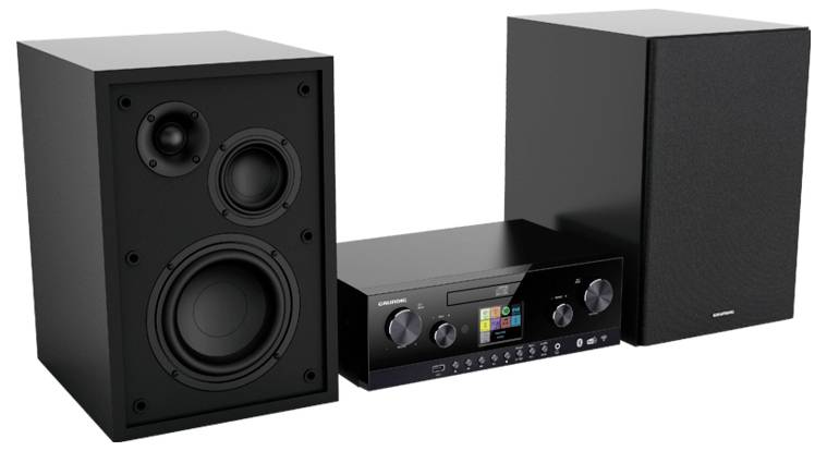 Ein schwarzes Stereosystem mit zwei Lautsprechern und einer zentralen Audioeinheit mit einem farbigen Digitalbildschirm, Tasten und Drehreglern für Bedienelemente.