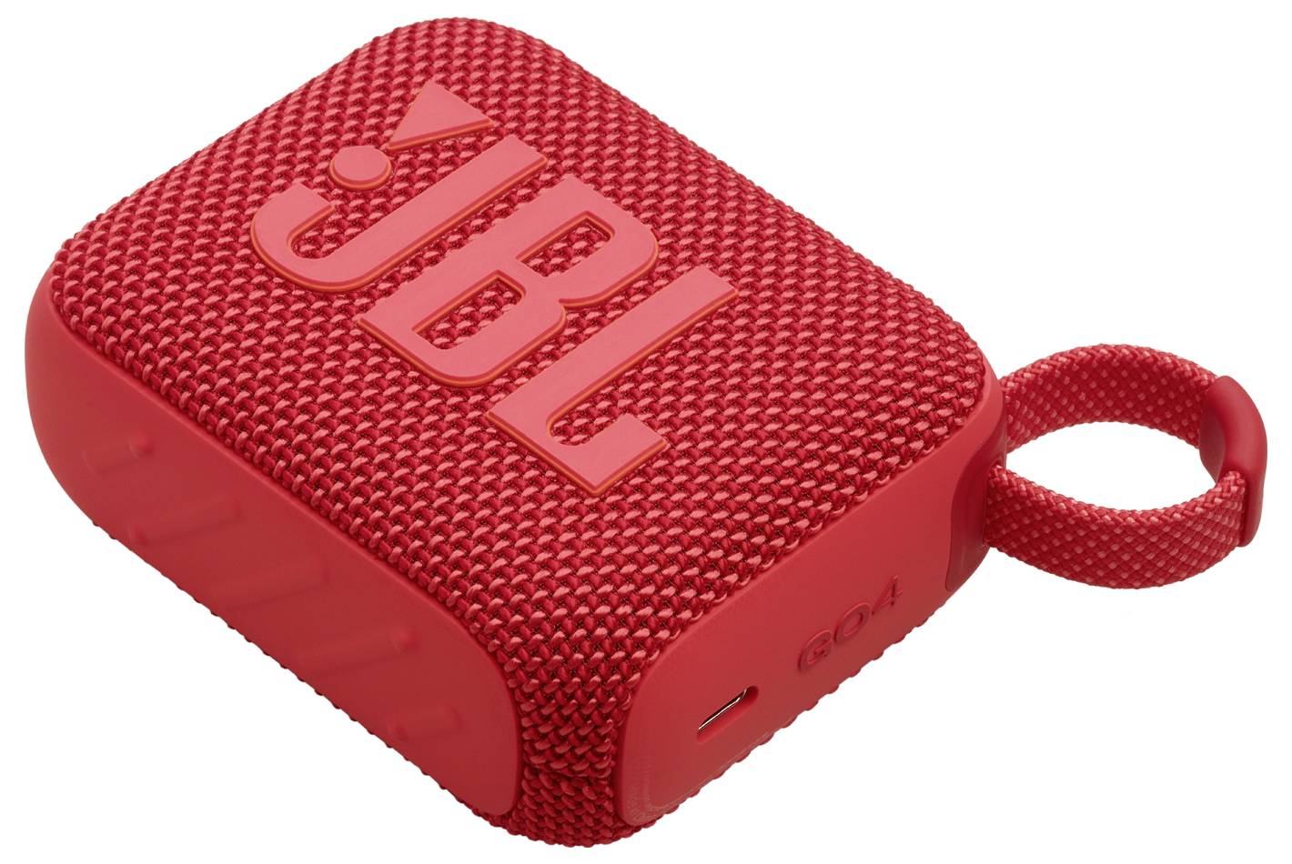 Ein roter rechteckiger tragbarer Bluetooth-Lautsprecher mit einer Schlaufe zum Tragen. Er ist mit strukturiertem Stoffbezug überzogen und trägt eine auffällige 'JBL' Markierung auf der Oberseite.