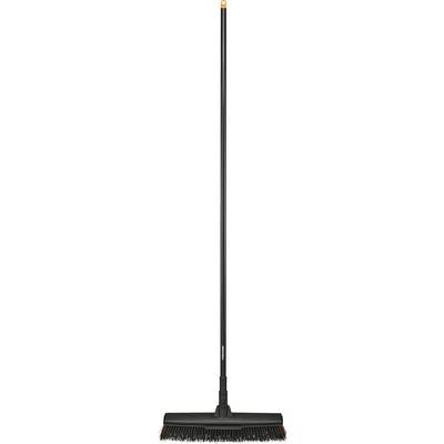 Eine schwarze Kehrbesen mit einem orangefarbenen Stielende, ausgestattet mit dichten Borsten, die aufrecht steht.
