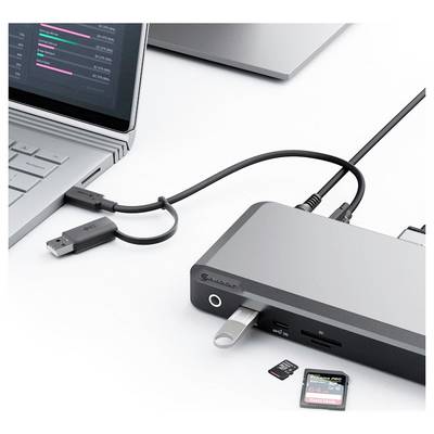 Eine Dockingstation, die mit einem Laptop verbunden ist, ermöglicht Verbindungen mit mehreren Geräten und zeigt USB- und SD-Kartensteckplätze mit angeschlossenen Geräten.