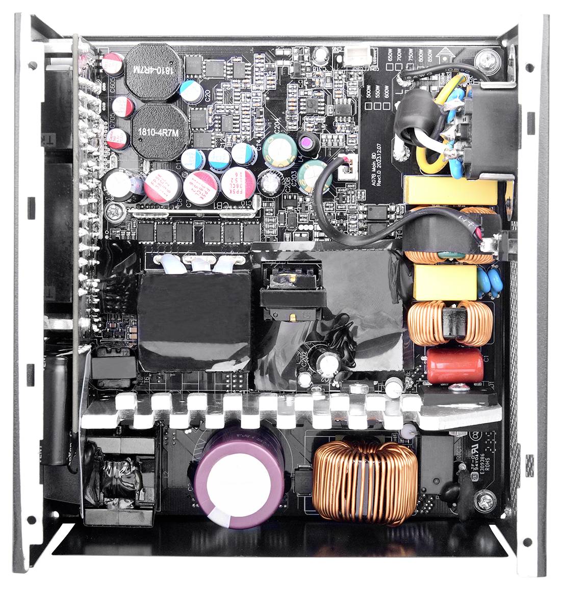 Innenansicht eines Computernetzteil, die Kondensatoren, Spulen und Verkabelung zeigt und elektronische Komponenten und Schaltkreise hervorhebt.