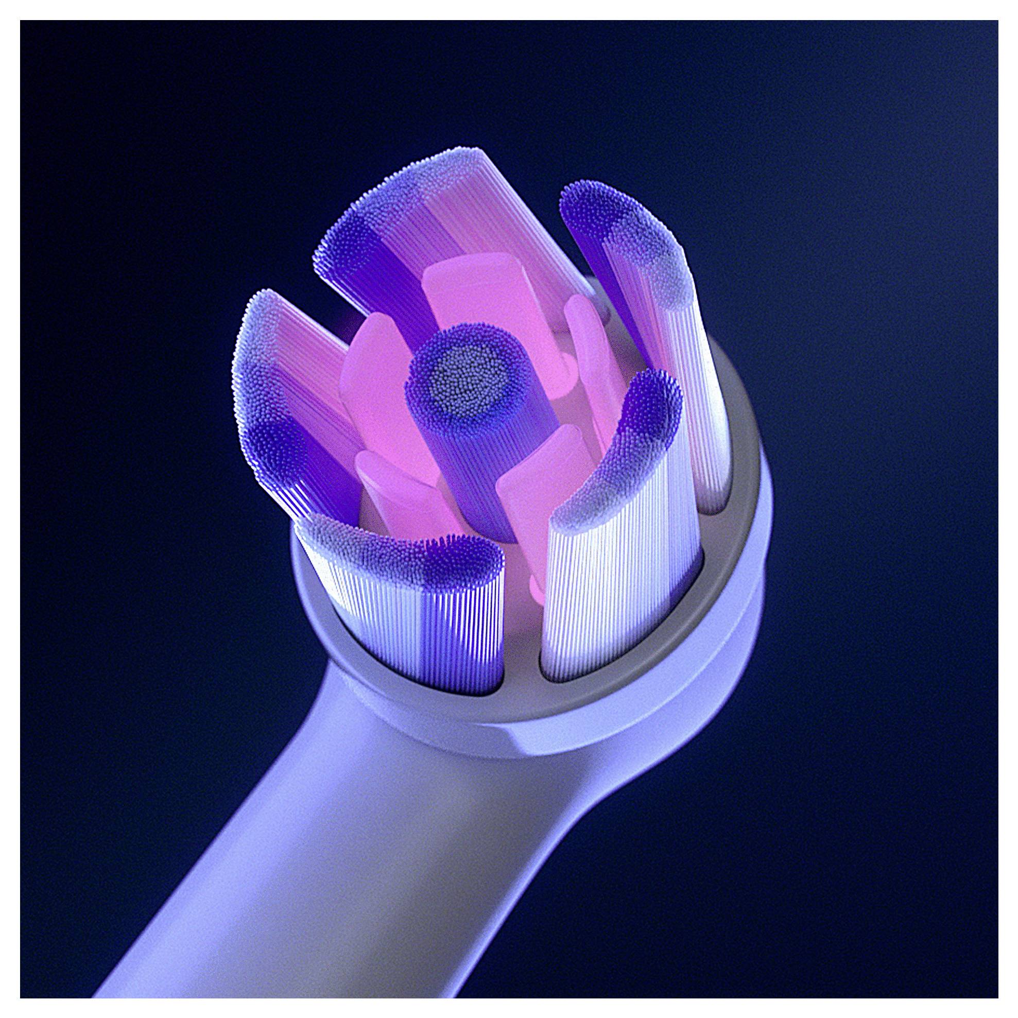 Elektrische Zahnbürste mit blauen und pinken Borsten, die vor einem dunklen Hintergrund beleuchtet sind.