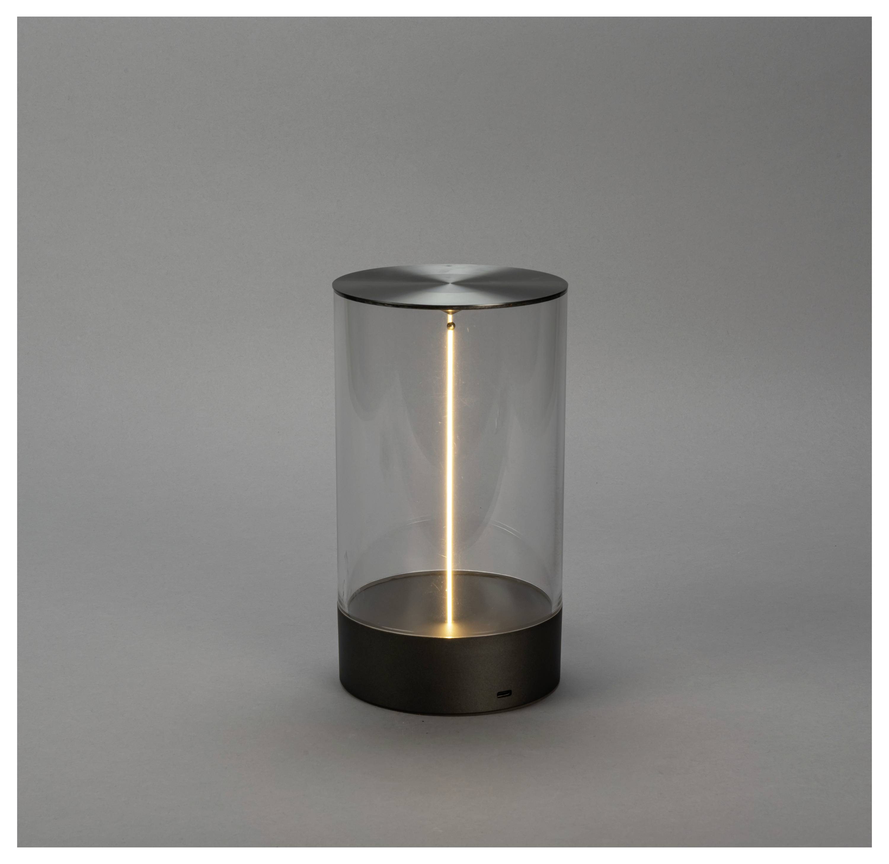 Eine elegante, transparente Zylinder-Lampe mit einem vertikal leuchtenden LED-Licht im Inneren, vor einem neutralen grauen Hintergrund.