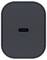 Ein schwarzer, abgerundeter rechteckiger Knopf mit einem kleinen horizontalen Schlitz in der Mitte, der einem USB-C-Anschluss ähnelt, auf einer strukturierten Oberfläche.