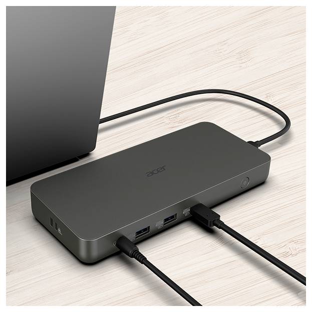 Acer-Dockingstation, die mit einem Laptop verbunden ist und deren mehrere Anschlüsse von Kabeln belegt sind, auf einer Holzoberfläche platziert.