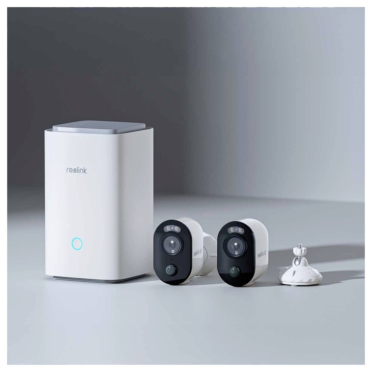 Heimsicherheitssystem mit Smart-Hub und zwei drahtlosen Kameras in minimalistischem weißem Design.