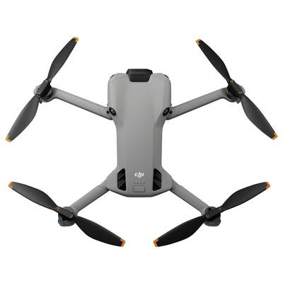 Eine graue Quadcopter-Drohne mit vier ausgestreckten Propellern, die ein kompaktes Design und eine kleine Kamera an der Front für Luftaufnahmen aufweist.