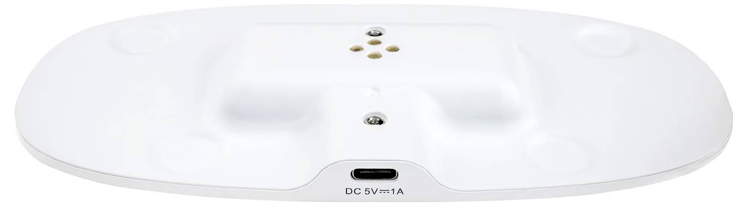 Weiße elektronische Basiseinheit mit zentralem DC 5V/1A Ladeanschluss, mit einem erhöhten Bereich mit Belüftungsöffnungen und zwei kreisrunden Füßen.
