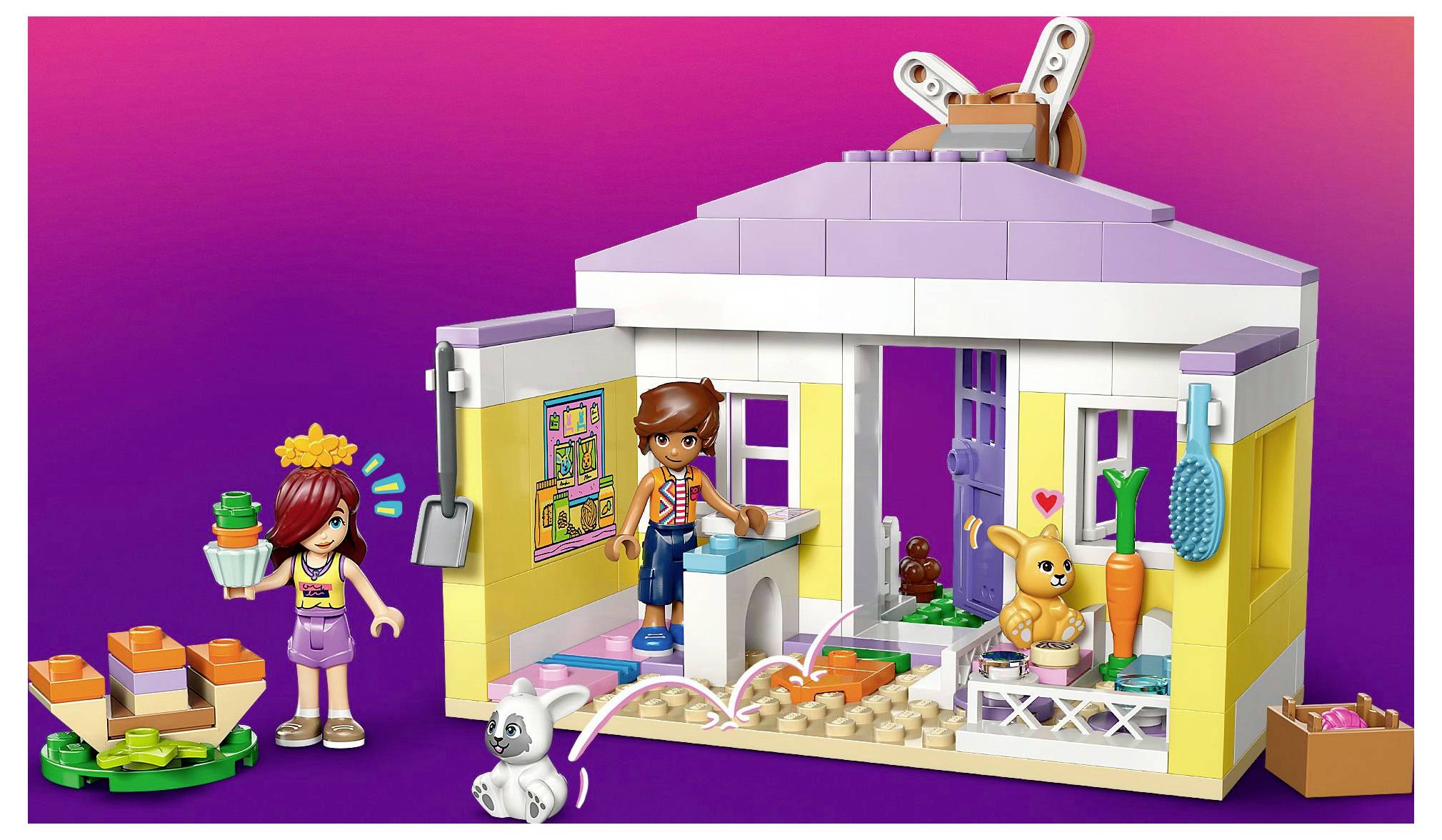 Kinderspielzeug-Set mit einem bunten Haus, einem Welpen, einem Möhren-Garten, Kinderfiguren und verschiedenen haustierThematischen Zubehörteilen.