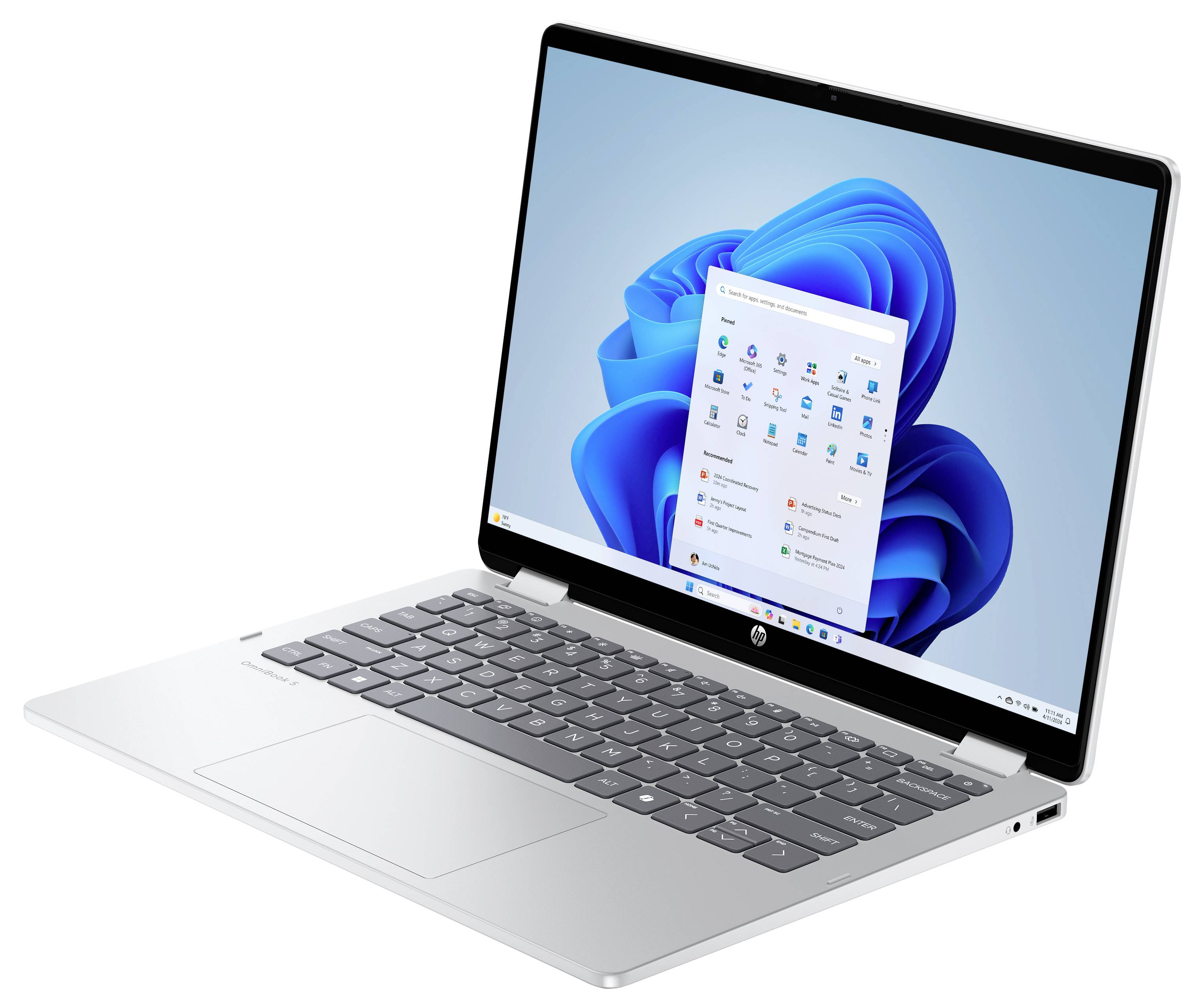 Ein moderner silberner Laptop, der ein Windows-Betriebssystem auf dem Bildschirm anzeigt, mit verschiedenen Anwendungssymbolen und einer Taskleiste.