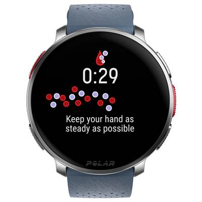 Smartwatch zeigt "Halten Sie Ihre Hand so ruhig wie möglich" mit einem roten Tropfensymbol und einem Timer bei 0:29 Sekunden.
