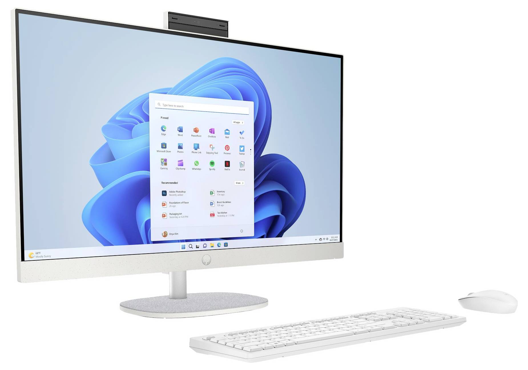 Ein moderner All-in-One-Desktop-Computer mit elegantem Design, Tastatur und Maus, auf dem ein Windows-11-Startbildschirm mit geöffneten Apps zu sehen ist.