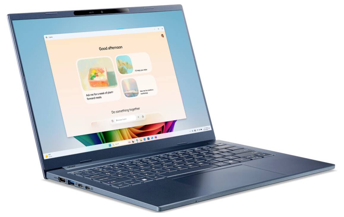 Ein schlanker, offener Laptop mit einer farbenfrohen Homepage auf dem Bildschirm, die einen "Guten Tag" Gruß und verschiedene digitale Aktivitätsoptionen zeigt.