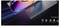 Ein schlanker, futuristischer Laptop, teilweise geöffnet, mit lebendigen, farbenfrohen Bildschirmgrafiken. Icons darunter deuten auf Kompatibilität mit Switch, Xbox, PS4/5, Smartphone und Laptop hin.