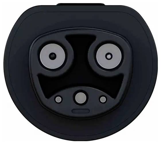 Ein schwarzes, kreisförmiges Gerät, das einem Gesicht mit zwei runden Augen, einem U-förmigen Mund und kleinen kreisrunden Sensoren ähnelt, möglicherweise ein Ladegerät.